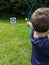 Boy fires arrow dart at a target with his bow