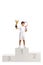 Boy first place tennis winner with a trophy cup standing on a winner`s pedestal