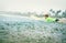 Boy first step surfer learning to surf under tropical rain