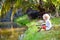 Boy fishing. Child with rod catching fish in river