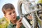 Boy Fixing Wheel Of Bike