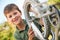 Boy Fixing Wheel Of Bike