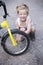 Boy Fixing Wheel Of Bike. Childhood.Cycling