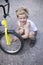 Boy Fixing Wheel Of Bike. Childhood.Cycling
