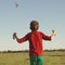 Boy flies kite into blue sky