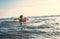 Boy floats on surf board. Beginner surfer, first lessons