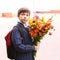 Boy with flowers at the first of September school day