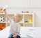 Boy flying paper airplane in bedroom