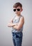 Boy with folded arms and sunglasses