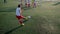 Boy footballer is kicking ball into goal through wall of players