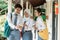 a boy and friends high school students look together with point to the mobile phone screen while chatting together