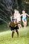 Boy with friends splashing in lawn sprinkler