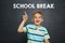 Boy in front of school board with text SCHOOL BREAK