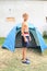 Boy in front of tent