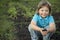 Boy in the garden admires the plant before planting. Green Sprout in Children Hands