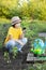 Boy in the garden admires the plant before planting. Green Sprout in Children Hands