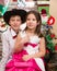 Boy gentleman and girl in ball dress by fireplace. Christmas