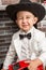 Boy gentleman in hat by fireplace. Christmas and New Year