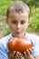 Boy with giant tomato