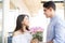 Boy Gifting Flowers To Girlfriend As Love Token In Mall