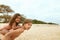 Boy And Girl On Beach. Tanned Sister On Brother s Back Spending Time On Coast. Positive Siblings Covered With Sand.