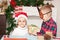 Boy and girl brother and sister give each other christmas gifts