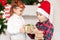 Boy and girl brother and sister give each other christmas gifts