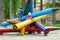 Boy and girl climbing giant colorful wooden pencils on the children playground in city park