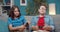 Boy and girl on couch with joysticks failing in video games