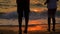 Boy And Girl Dancing On The Beach At Sunset