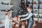 Boy and girl dressed elegantly standing in a bright room by the fireplace. Christmas tree in the background. New year concept.