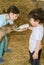 Boy and girl feeding bay goat