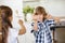 Boy and girl fighting in fun with spoons