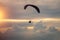 Boy and girl flying on a paraglider on a background of clouds