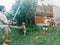 Boy girl friends siblings splashing playing under water on backyard on hot summer day