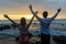 Boy Girl Hands Happy Ocean Rocks Silhouetted