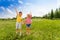 Boy and girl hold hands with second hand up