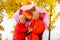 Boy and girl hold umbrella together under rain