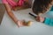 Boy and girl looking at giant snail through magnifying glass