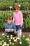 Boy and girl in looking at narcissus at greenhouse