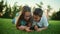 Boy and girl lying on grass with cellphone. Brother and sister using smartphone