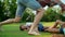 Boy and girl lying on grass in field. Father and kids playing with ball in park