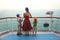 Boy and girl with mother standing on ship deck