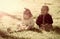 Boy and girl pick flowers on green grass