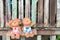 Boy and girl plaster dolls sitting on the swings, wooden background