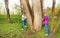 Boy with girl play hide and seek in the forest