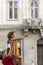 Boy and girl playing in city square. Children catch soap bubbles