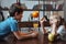 Boy and girl playing with glasses and fruits at kitchen together