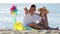 Boy and girl pointing with finger on sandy beach