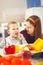 Boy and girl preparing and eating healthy meal at home